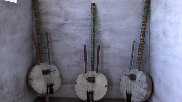 Three Koras leaning against a wall. Koras handcrafted musical instruments