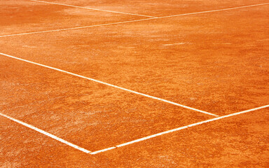Clay tennis court. Surface outside back and side lines. Diagonal View.
