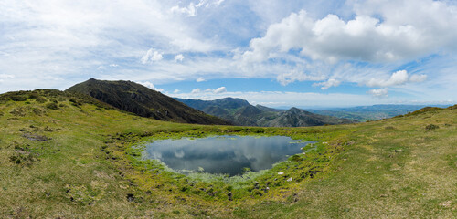 Fototapeta premium Small lake on the way to La Múa peak, in the Council of Nava, Asturias, Spain