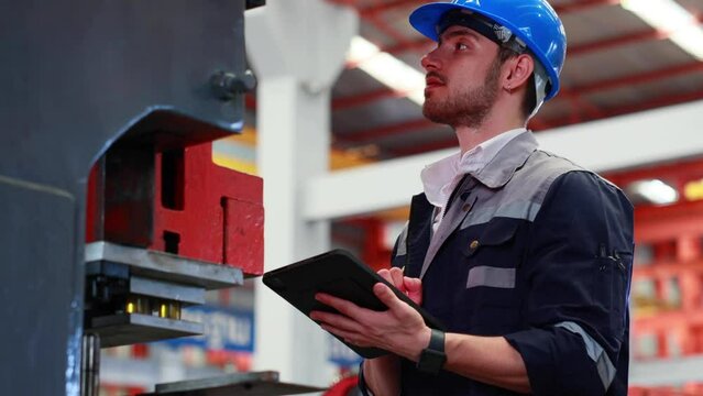 lathe and stamping metal machine. Hispanic man and Factory engineer in hard hat helmet working on digital teblet computer at Heavy Industry Manufacturing Factory.