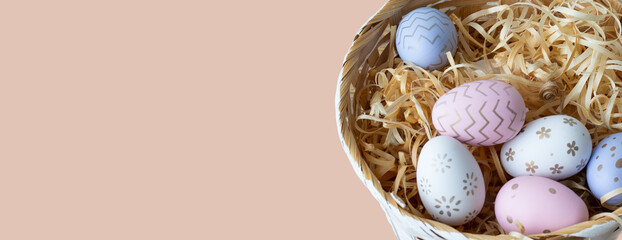 Banner. Easter eggs. Colored in a basket. on a pink background. Close-up. High quality photo. Copyspace