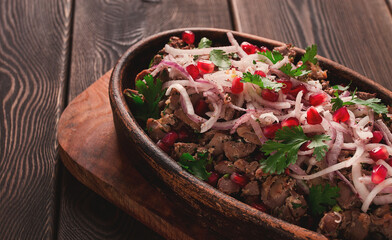 Kuchmachi, a traditional Georgian dish, in a clay Ketsi plate, close-up,