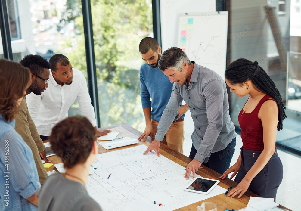 Poster design is creativity with strategy. cropped shot of a group of architects in the boardroom.