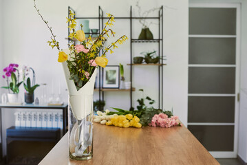 beautiful young florist makes a bouquet