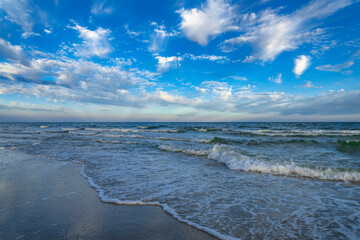Fototapeta na wymiar Evening sea beach, sand, blue sky. Marine relaxation landscape after sunset