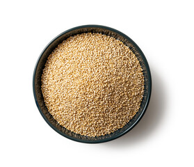 White quinoa seeds in a blue ceramic bowl isolated on a white background. Dry chenopodium quinoa grains on a plate cutout. Gluten free superfood for vegetarian healthy eating concept.