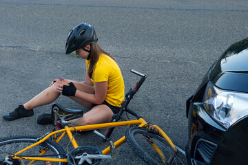 Naklejka premium Situation stock photo showing cyclist after car accident 