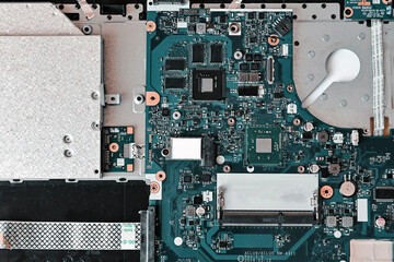 Fototapeta premium laptop repair. disassembled laptop, troubleshooting, fault diagnosis, problem search, motherboard (main board) close-up. top view