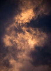 Naklejka na ściany i meble Turbulent Storm Clouds Backlit by the Setting Sun