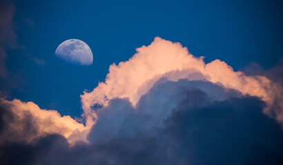 Moon Rising Above Gathering Storm Clouds