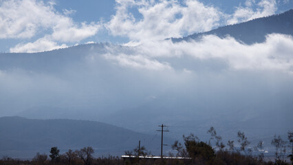Fototapeta na wymiar Mountain with a blanket of clouds
