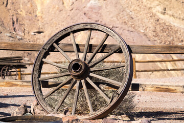 Old wagon wheel leaning on a fence © Allen Penton