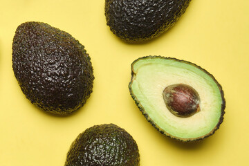 macro image of avocados on yellow background from above