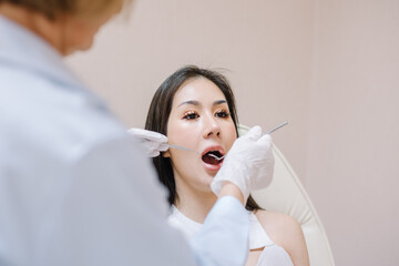 Woman having teeth examined at dentists