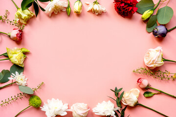 Fototapeta na wymiar flowers, buds of flowers, roses and chrysanthemums, carnations on a pink background, buds and leaves lie beautifully with a place for text and congratulations