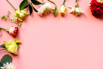 flowers, buds of flowers, roses and chrysanthemums, carnations on a pink background, buds and leaves lie beautifully with a place for text and congratulations
