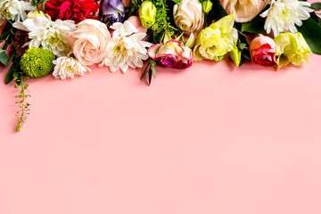 flowers, buds of flowers, roses and chrysanthemums, carnations on a pink background, buds and leaves lie beautifully with a place for text and congratulations