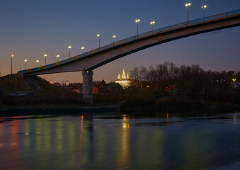 Fototapeta na wymiar bridge over river and St.Catherine`s church at night in Chernihiv, Ukraine