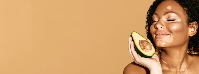 Moisturizing and care for pigmented skin using cosmetics with avocado, web banner. Smiling woman...