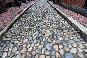 Empty historic old cobblestone alleyway street 