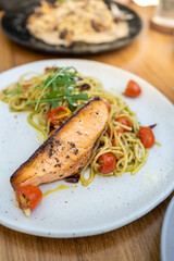 pasta spaghetti green pesto sauce with grilled salmon fillet - Italian food style