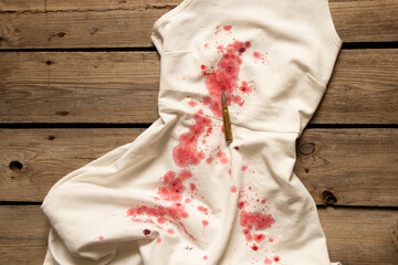 White women's dress in drops of blood and a bullet, a crime scene, a woman's murder, blood on things