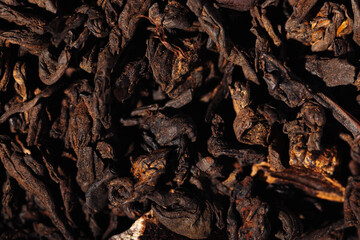 Chocolate black leaf shu pu-erh tea with cocoa beans close-up macro photography