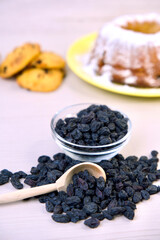 Cookies and muffin with raisins in a bowl, on a wooden background, baking. vertical frame