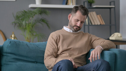 Fototapeta premium Man Taking Nap While Sitting on Sofa