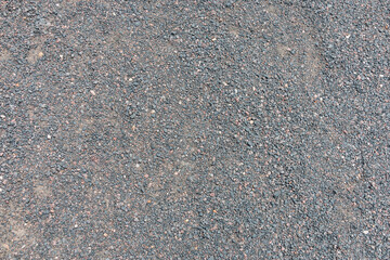 Texture of dark gray asphalt with small stones. Background. Texture.