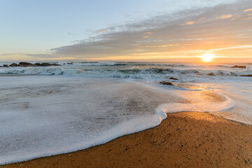 Atlantic ocean beach in the evening at sunset.