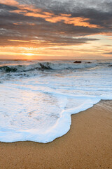 Atlantic ocean beach in the evening at sunset.