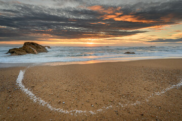 Fototapeta na wymiar Atlantic ocean beach in the evening at sunset.