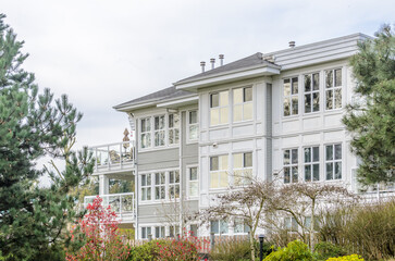 modern apartment building with beautiful spring blossom landscape