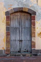 Old wooden door in the Bovedas area, French Plaza area of Old Quarter, known as Casco Viejo in Panama, Panama, Central America