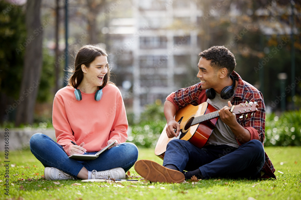 Poster ive been working on a song for you. shot of two students sitting together on campus.