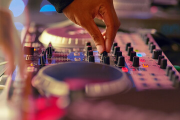 Lets get this party started. Closeup shot of a DJ mixing music on a turntable.