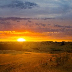 wide sandy desert at the dramatic sunset
