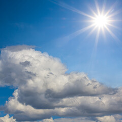 sparkle sun among dense cumulus clouds, natural cloudy sky background