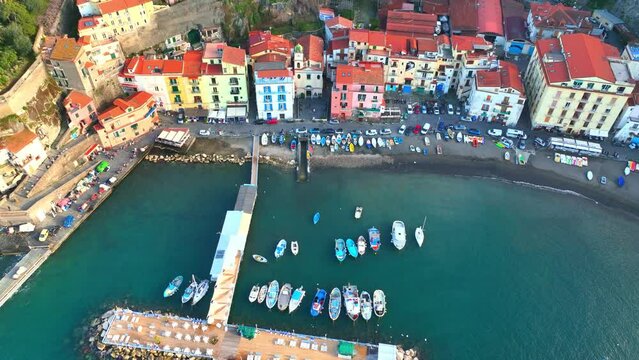 Amalfi coast in Italy near Sorrento with colourful houses and cliffs, aerial view in summer at sunset, seaside resort of Sorrento from above, tourism in southern Italy