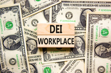DEI diversity equity inclusion workplace symbol. Blocks with words DEI workplace on beautiful background from dollar bills. Business DEI diversity equity inclusion workplace concept. Copy space.