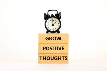 Grow positive thoughts symbol. Concept words Grow positive thoughts on blocks. Beautiful white...