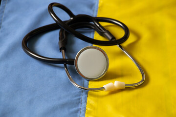 The stethoscope lies on the national flag of Ukraine yellow-blue, martial law in Ukraine, medical care during the war