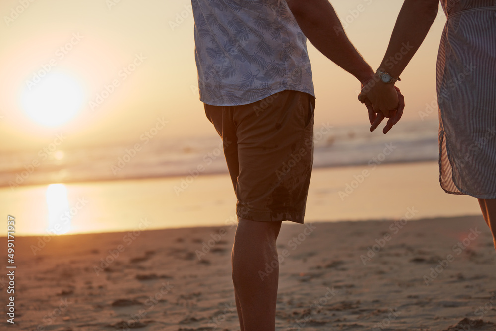 Poster You hand belongs with mine. Rearview shot of a mature couple spending quality time on the beach.