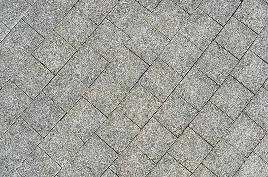 Street paved with cobblestone. paving stones, Background of natural stone texture.
