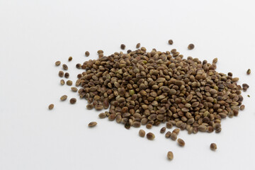 heap of cannabis seeds on white background, copy space top view horizontal. Banner, cover, mockup, for your design