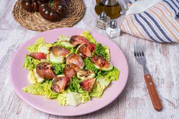 Lettuce, cucumber and raf tomato salad, seasoned with olive oil, salt and balsamic vinegar.