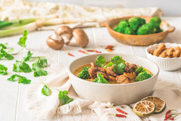 Vegan Tom Kha Gai soup with various vegetables and roasted soy-based meat substitutes
