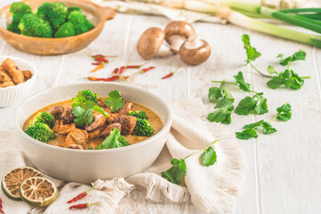 Vegan Tom Kha Gai soup with various vegetables and roasted soy-based meat substitutes