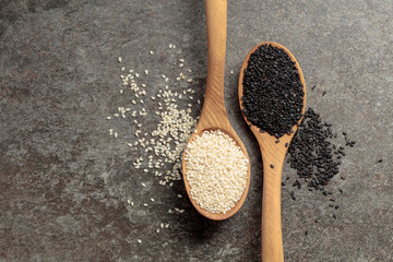 Wooden spoons with black and white sesame seeds.